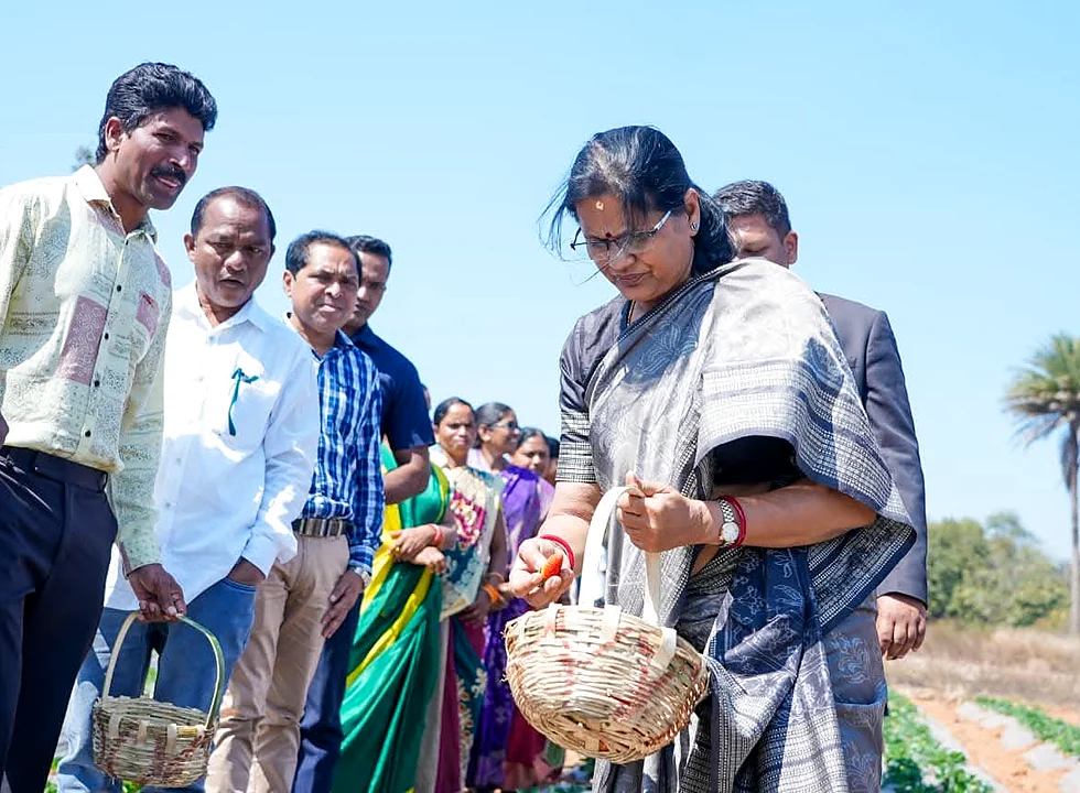 Deputy CM with local participants and SHG members near a strawberry field