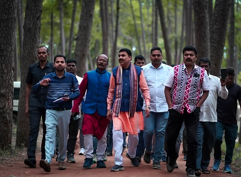 Officials walking on a shaded Pine Forest trail in Daringbadi
